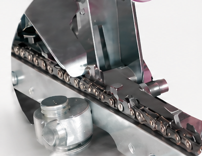 Close-up of a chainsaw chain positioned in the 230W sharpener guide